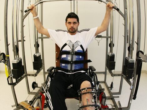 patient lifting weights to strengthen back and shoulders