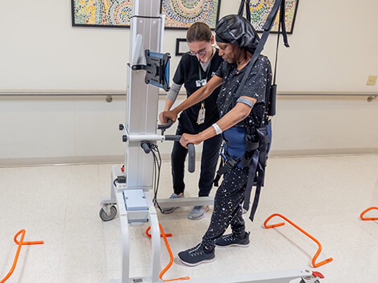 Adult male cancer patient walks on treadmill as part of cancer rehabilitation exercises