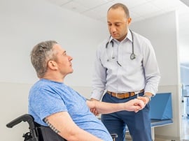 Two Physicians standing at the nurses station