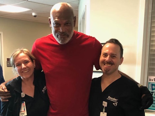 Photo of Dwayne Gland and his therapists at Kessler Institute for Rehabilitation.