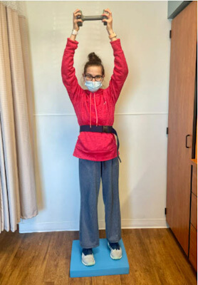 Photo of Sara Shissias doing balancing exercises at Kessler Institute for Rehabilitation.