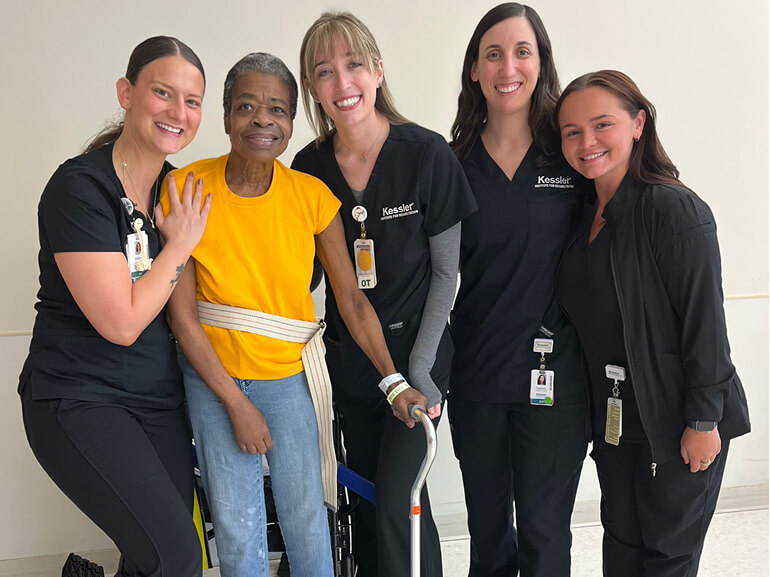 Photo of Jeannette Bonner Secrest with her rehabilitation team at Kessler Institute for Rehabilitation.