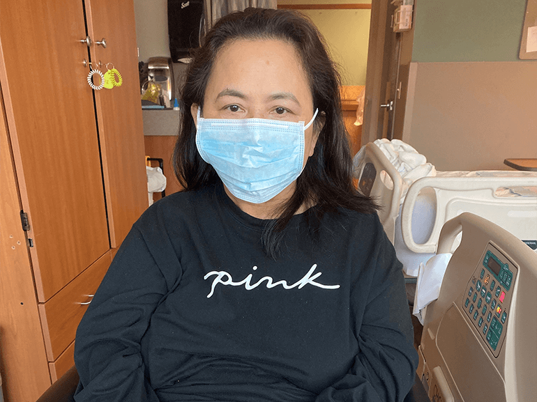 Anabelle Del Valle sitting in a wheelchair with a mask on.